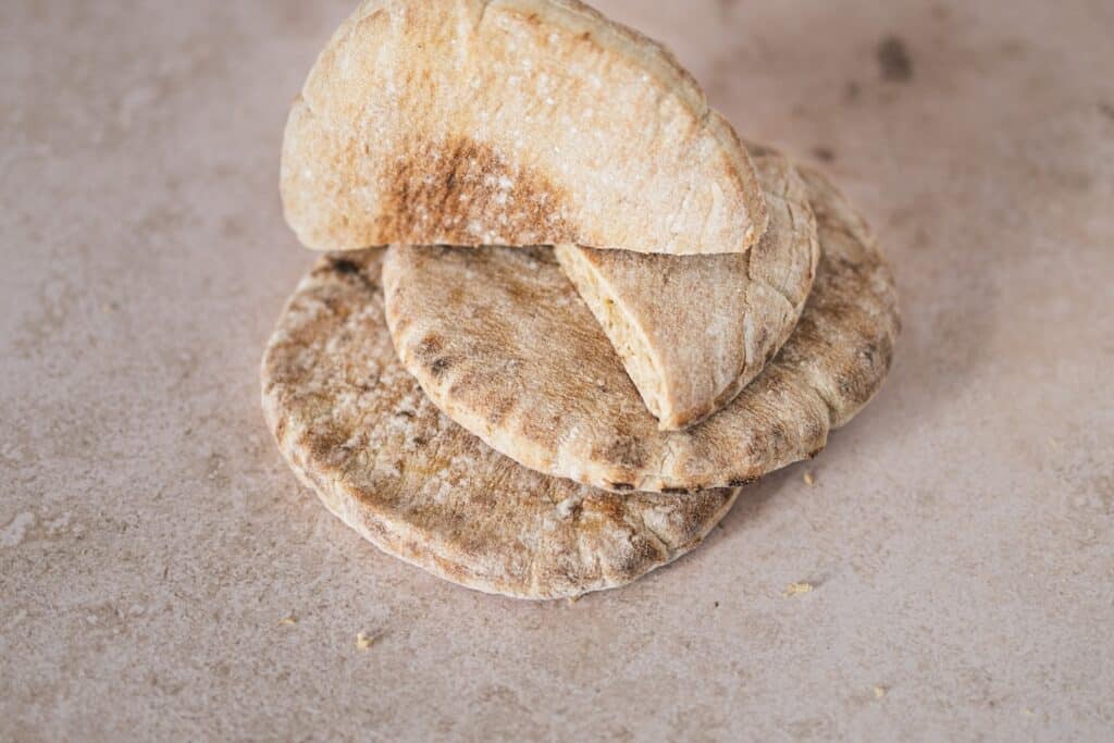 a pile of pita bread sitting on top of a table